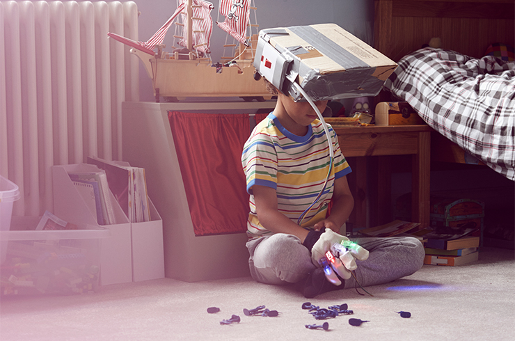 Kid using selfmade box helmet and tech gloves