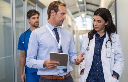 Two doctors talking together in an hospital corridor