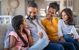 Family smiling on a couch