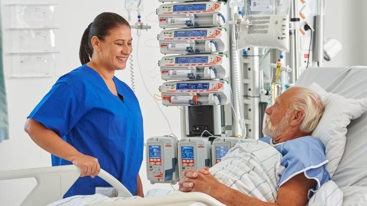 PK_CC_GP_female_nurse_smiling_at_elderly_male_patient_2_740x416