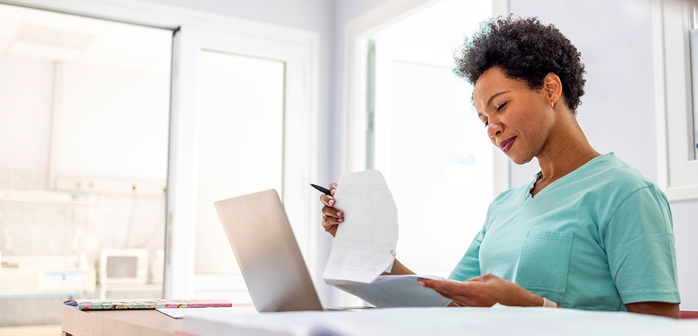 Woman at laptop viewing paper